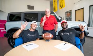 Houston Football's Clayton Tune and Donavan Mutin sign NIL deals with Chastang Ford's COO Patrick Chastang. | Image courtesy of Chastang Ford